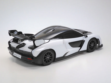 Tamiya TT-02 McLaren Senna RC car kit with detailed body shell and racing decals on a white background.