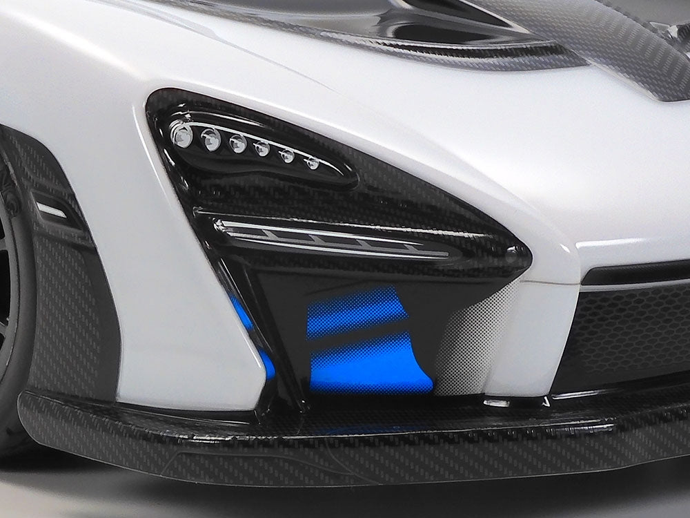 Tamiya TT-02 McLaren Senna RC car kit with detailed body and components, ready for assembly and customization.