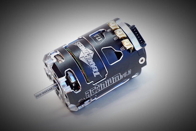 Team Powers Actinium V5 brushless motor for RC cars, shown with detailed metal components and wiring on a white background.