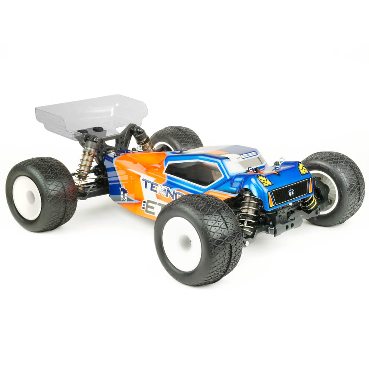 Tekno TKR7202 ET410.2 1/10th scale 4WD electric RC truggy kit on a track, showcasing its detailed chassis and rugged tires.