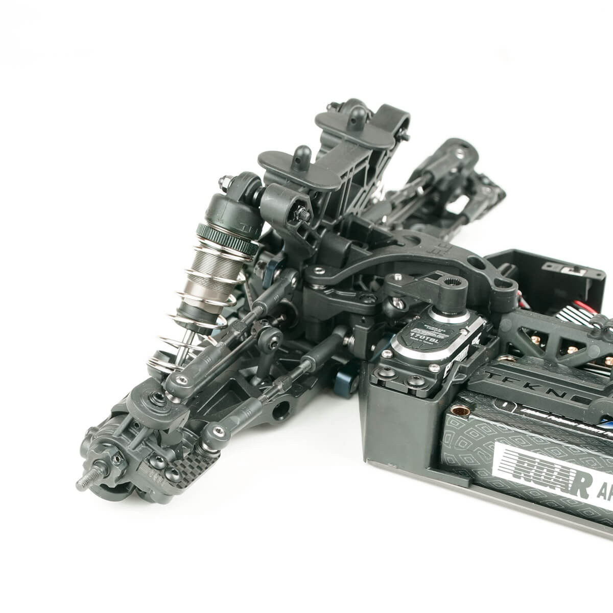 Tekno ET410.2 1/10th scale 4WD electric RC truggy kit on a track, showcasing its detailed chassis and rugged design.