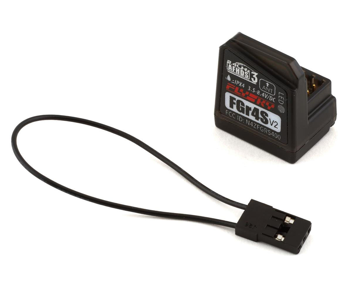 Flysky Noble FGR4S v2 RC receiver connected to radio transmitter, used for remote control drone or RC car.